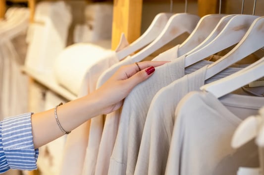 shopper-hand-selecting-clothing-rack