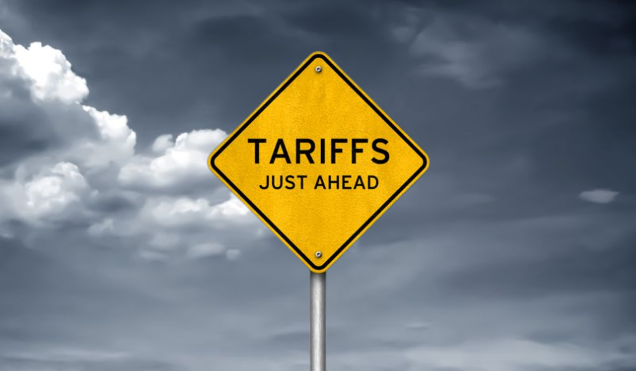 A yellow road sign reading 'Tariffs Just Ahead' against a cloudy sky, symbolizing challenges for retailers using AI-driven pricing software