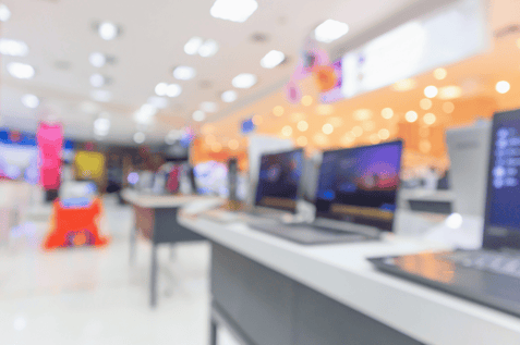 Tech retail aisle symbolizing inventory planning aimed at reducing lost sales in electronics.