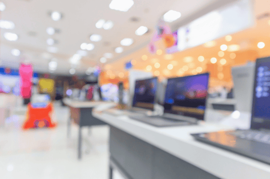 Tech retail aisle symbolizing inventory planning aimed at reducing lost sales in electronics.