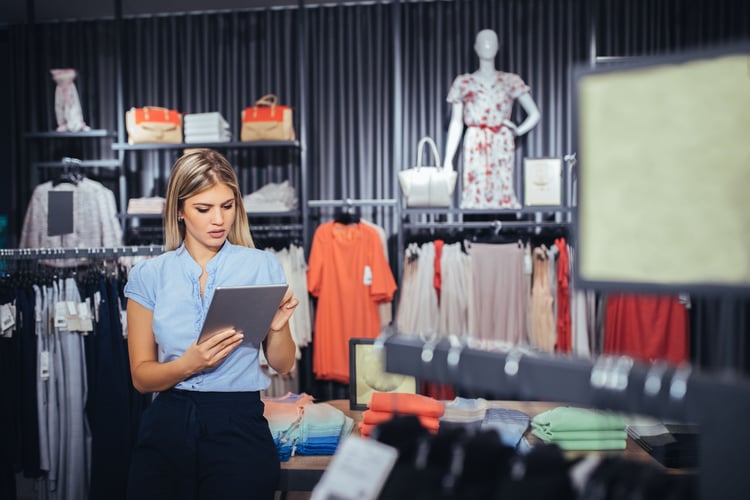 Woman looking a stock plan in retail forecasting
