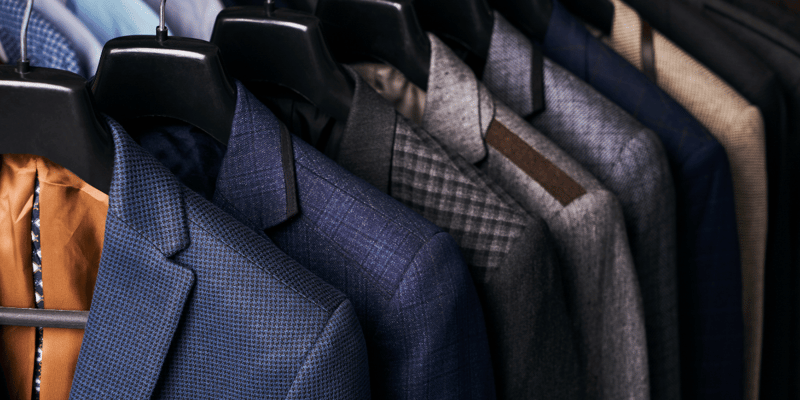 A collection of suits on display, representing Tailored Brands use of AI-driven inventory optimization to match demand with precision.