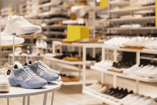 Sneaker section in a fashion store illustrating streamlined retail inventory and real-time product availability.