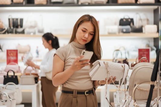 Shopper checking price in retailer store.