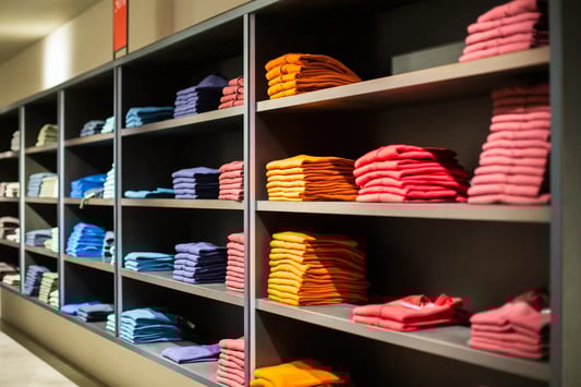 Department store shelves with limited stock, showing inventory-driven pricing decisions.