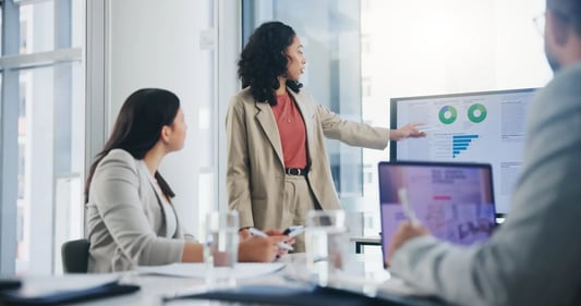 Charts and data visuals during a supply chain analytics meeting, highlighting performance trends and forecasting insights.