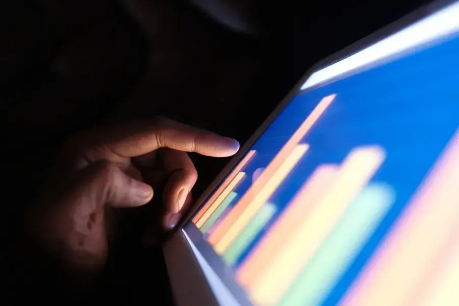 Person reviewing AI-powered inventory analytics dashboard for demand forecasting and inventory optimization