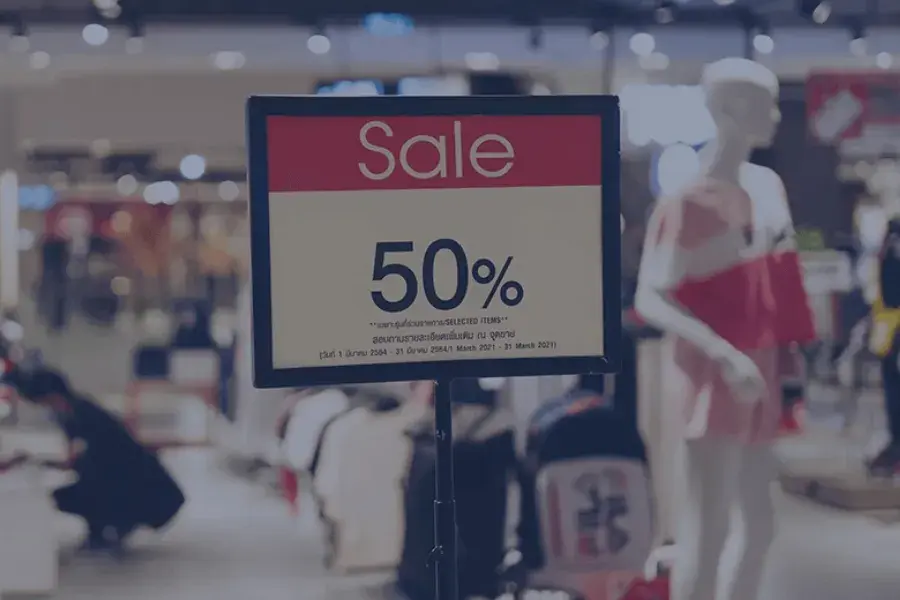 A retail store features a 50% off sale sign, showcasing a markdown optimization strategy to clear excess inventory. Retailers use data-driven markdown pricing and demand forecasts to make real-time pricing decisions, optimize markdown plans, and maximize profit margins.