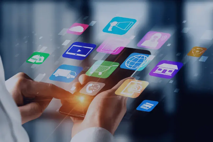 A person using a smartphone with floating icons, symbolizing the omnichannel customer experience across digital and physical channels.