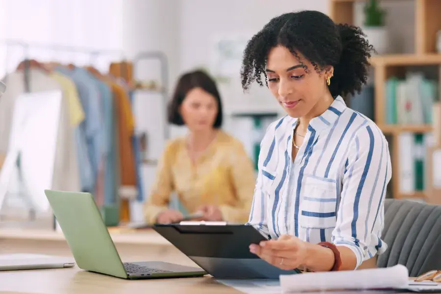 Retail planner reviews sales and forecasting models on a tablet to improve demand planning and streamline retail decision-making