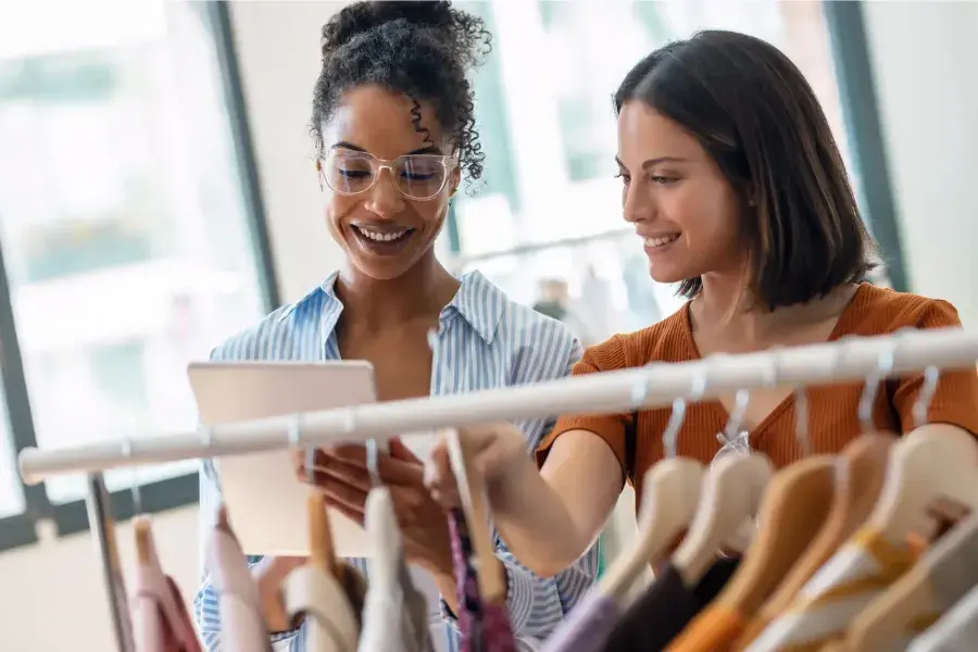 Team collaborating with a tablet to discuss promotional pricing, price optimization, and market positioning.