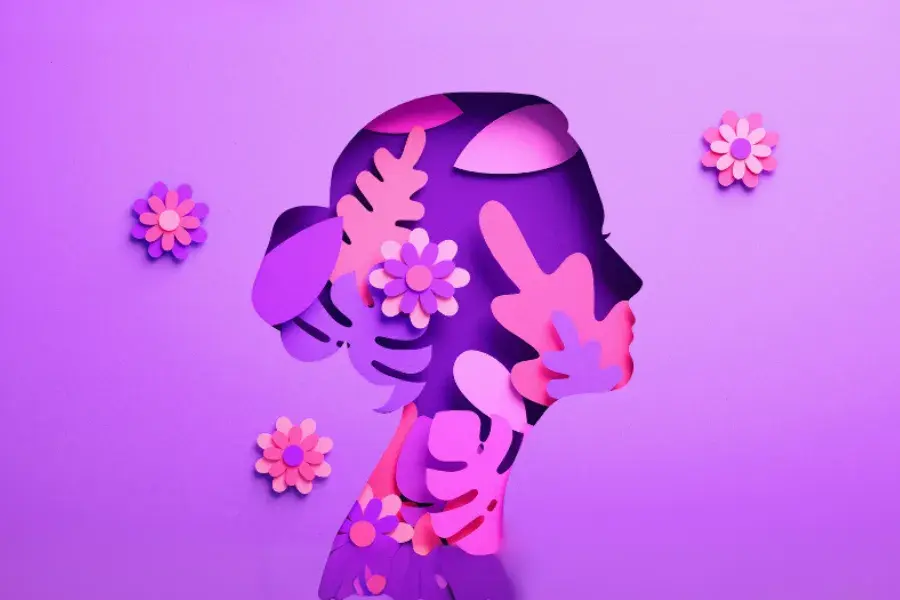 A vibrant woman with floral elements, symbolizing empowerment and leadership in retail for International Women’s Day.