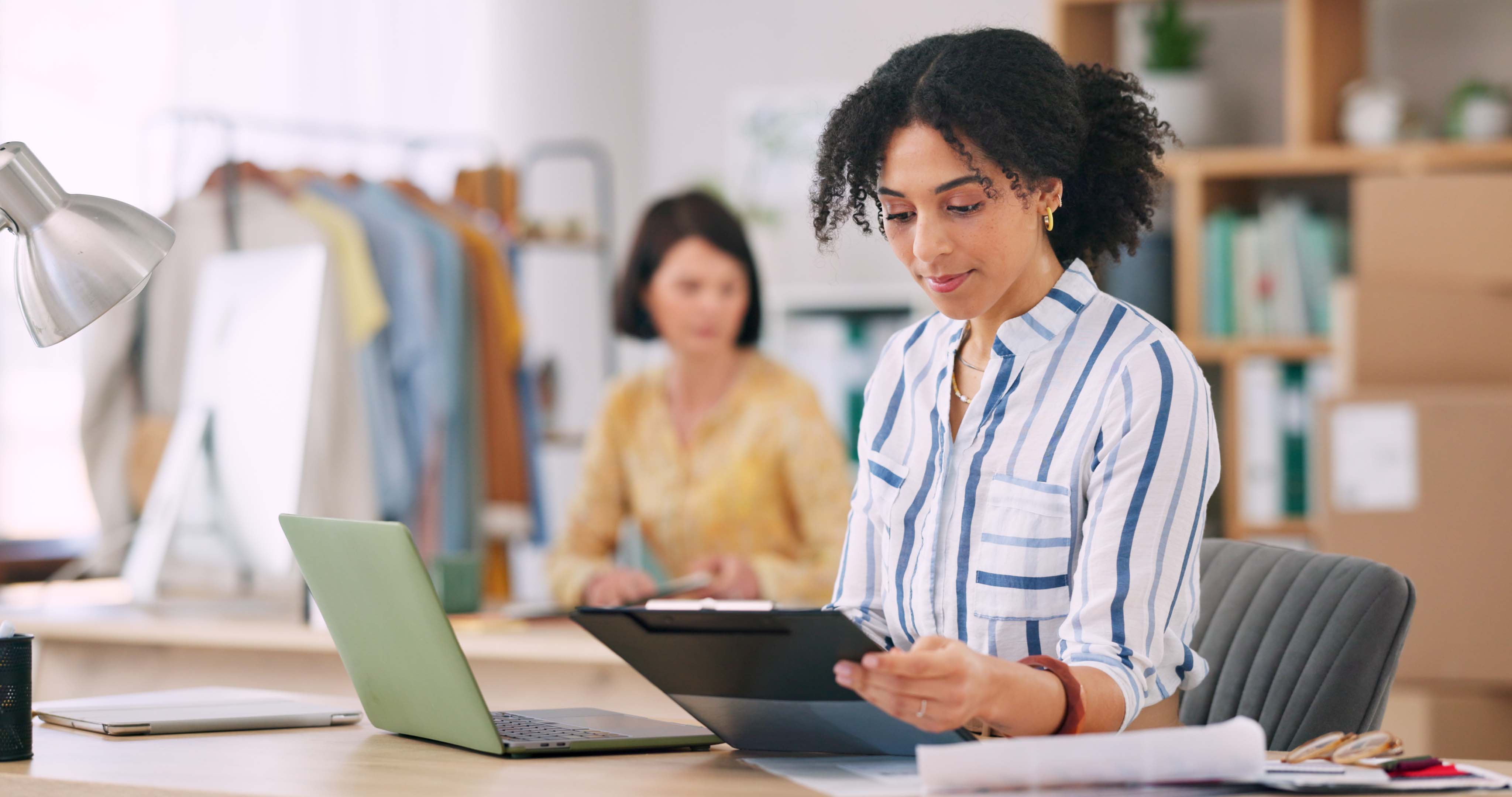 Retail planner reviews sales and forecasting models on a tablet to improve demand planning and streamline retail decision-making