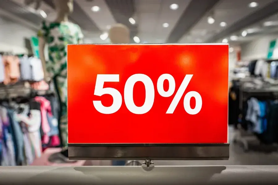 Retail apparel store with organized clothing displays, representing AI-powered inventory optimization and markdown strategy across global fashion brands.