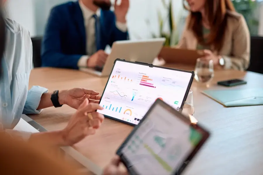 Merchandising experts reviewing business intelligence dashboards to improve sales optimization and retail merchandising strategies.