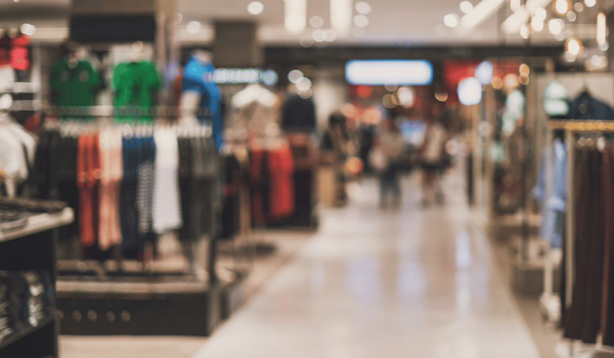 Blurred view of a fashion retail store, showcasing the benefits of markdown optimization solutions