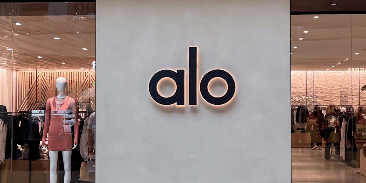 Alo store exterior with a minimalist logo and mannequins displaying apparel — representing inventory planning in retail.