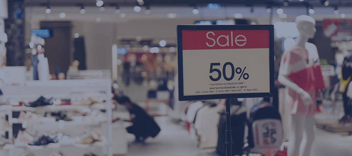 A retail store features a 50% off sale sign, showcasing a markdown optimization strategy to clear excess inventory. Retailers use data-driven markdown pricing and demand forecasts to make real-time pricing decisions, optimize markdown plans, and maximize profit margins.