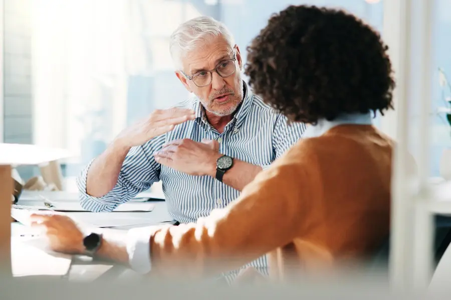 Team reviewing retail service provider options during planning meeting.